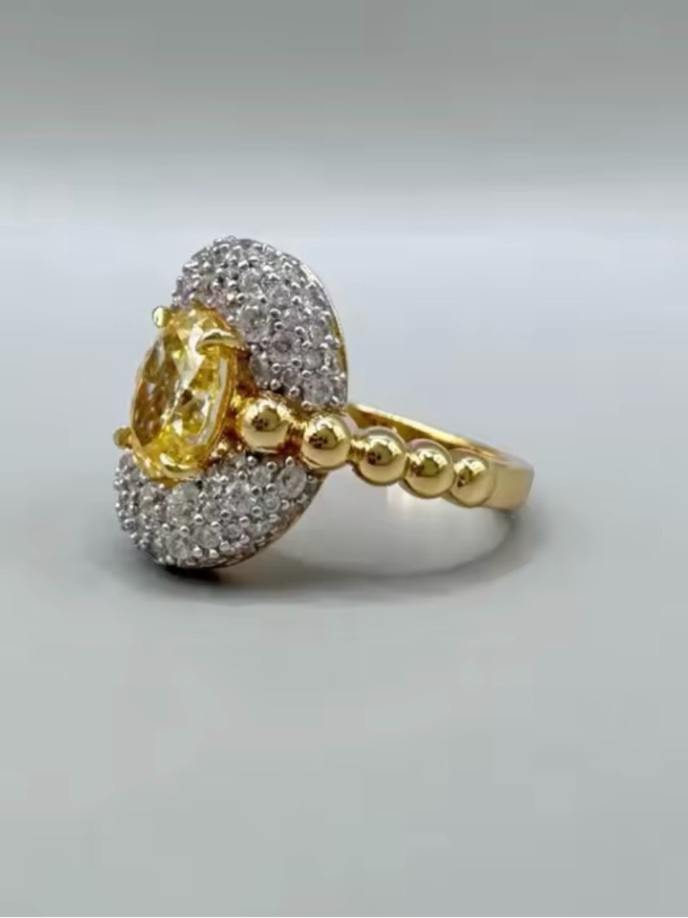 Gold Ring with Yellow Gemstone and Halo Accent